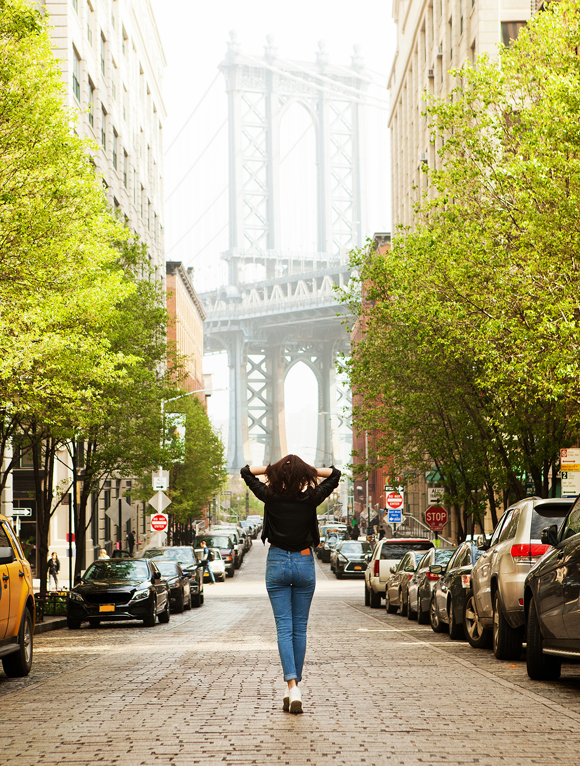 Woman walking down Brooklyn street.